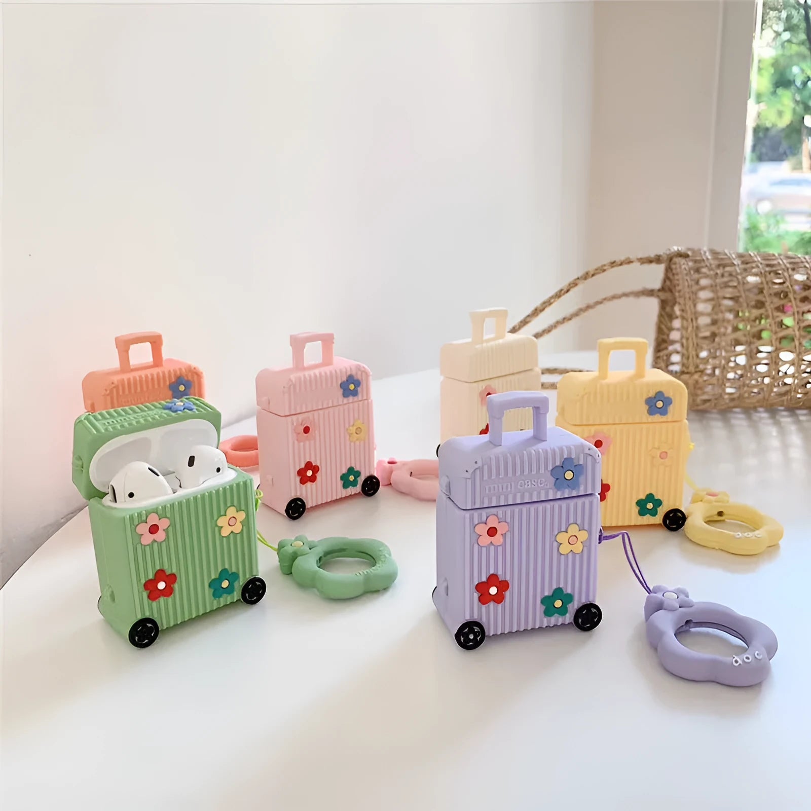 Silicone AirPods protective case in flip-style design showing colour options including pink, purple, white, green, orange, and yellow