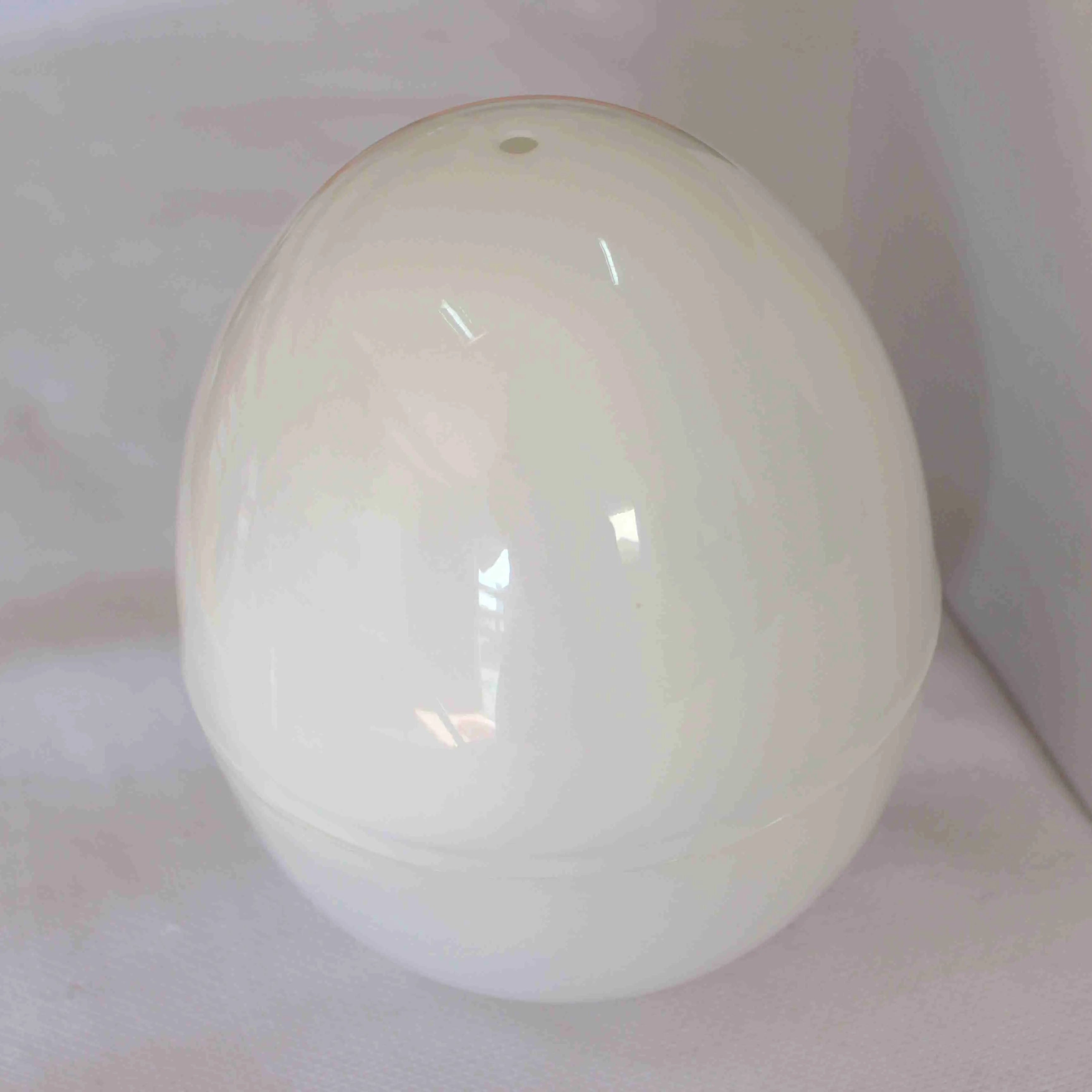 White microwave egg cooker with capacity for 4 eggs on kitchen counter