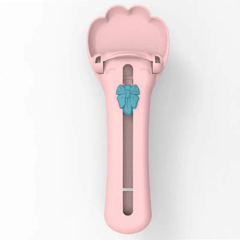 Green and pink pet feed spoon for snack extrusion and cereal dispensing with squeezer feeder design