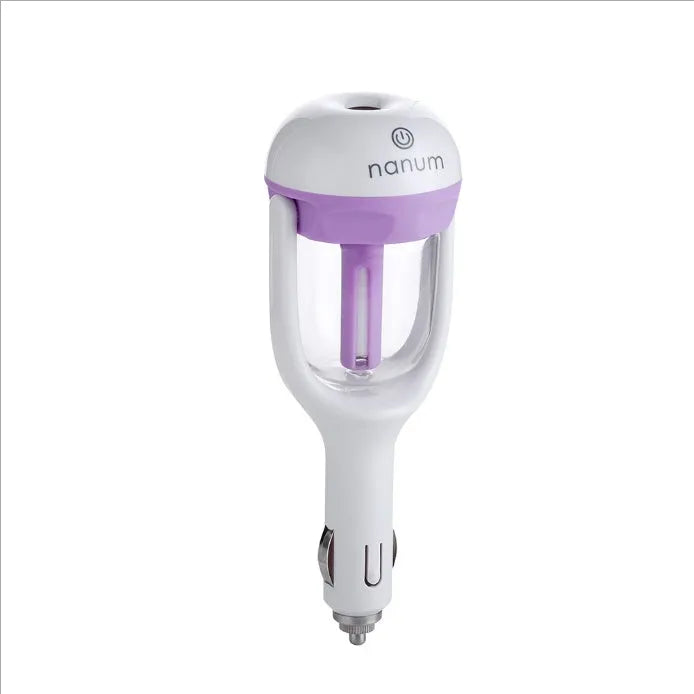Compact blue portable car humidifier and essential oil diffuser with rotating nozzle on a car dashboard.