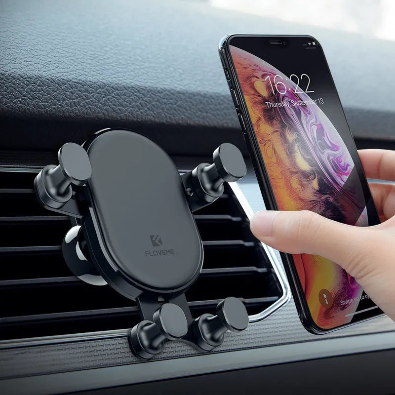 Black car phone holder with 360-degree rotation mounted on vehicle dashboard