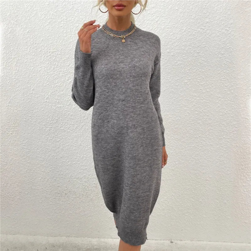 Grey women's crew neck acrylic sweater dress with long sleeves on a hanger.