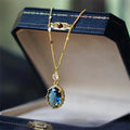 Gold-coloured geometric pendant necklace with a French retro design on a chain.