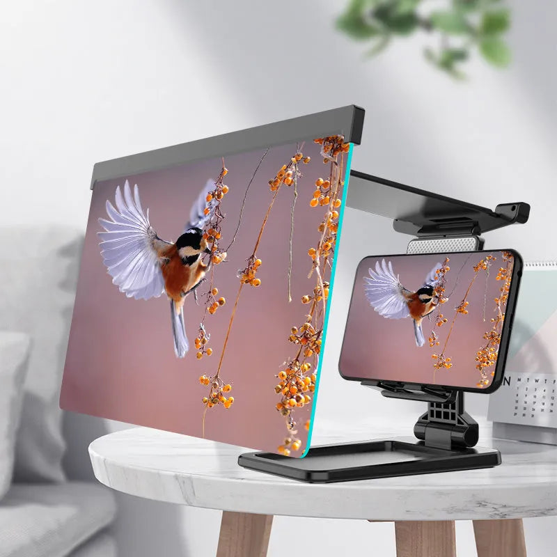 Black foldable mobile phone screen amplifier with detachable holder on a desk