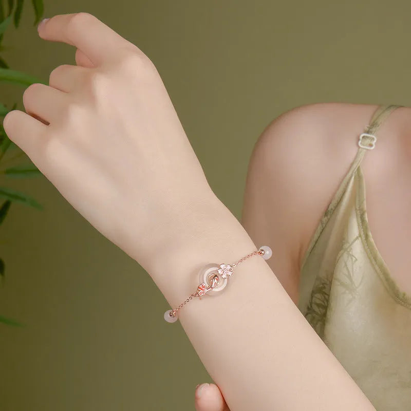 S925 sterling silver bracelet with white chalcedony crystals and a floral koi design.