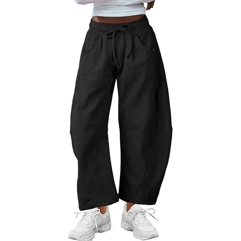 Loose cropped sweatpants with drawstring waist and side pockets in street fashion styling