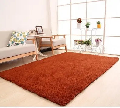 Solid colour plush carpet with soft surface and rectangular shape on hardwood floor