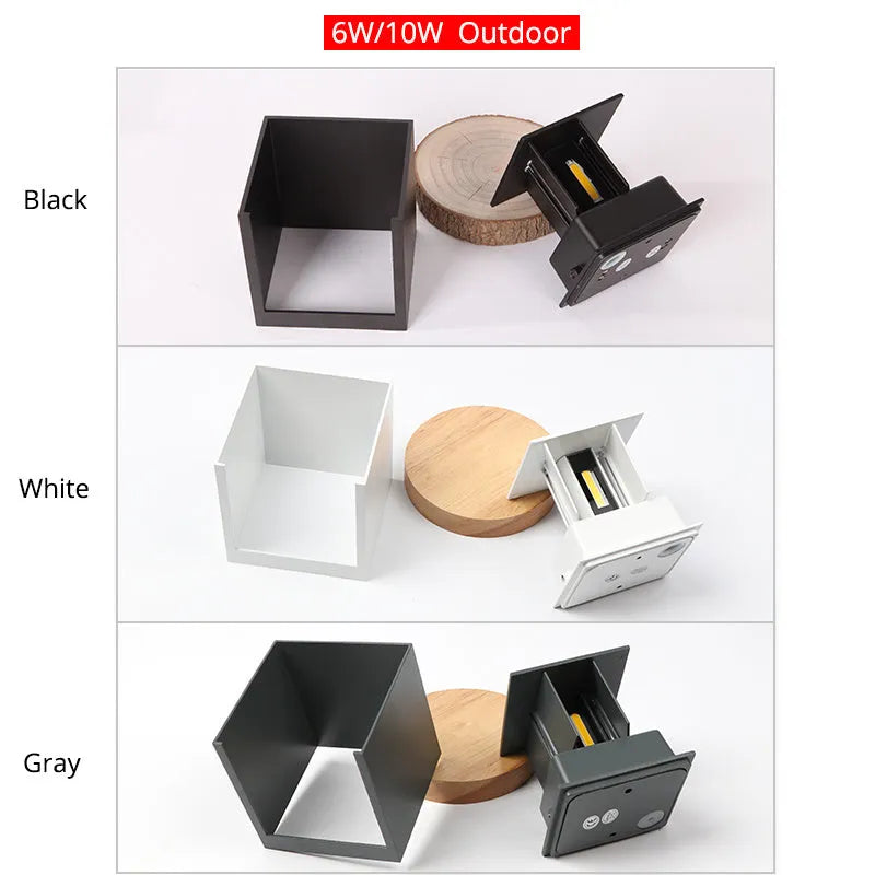Square aluminium wall lamp in black on a corridor wall, showing adjustable colour temperature settings from warm to cool light.