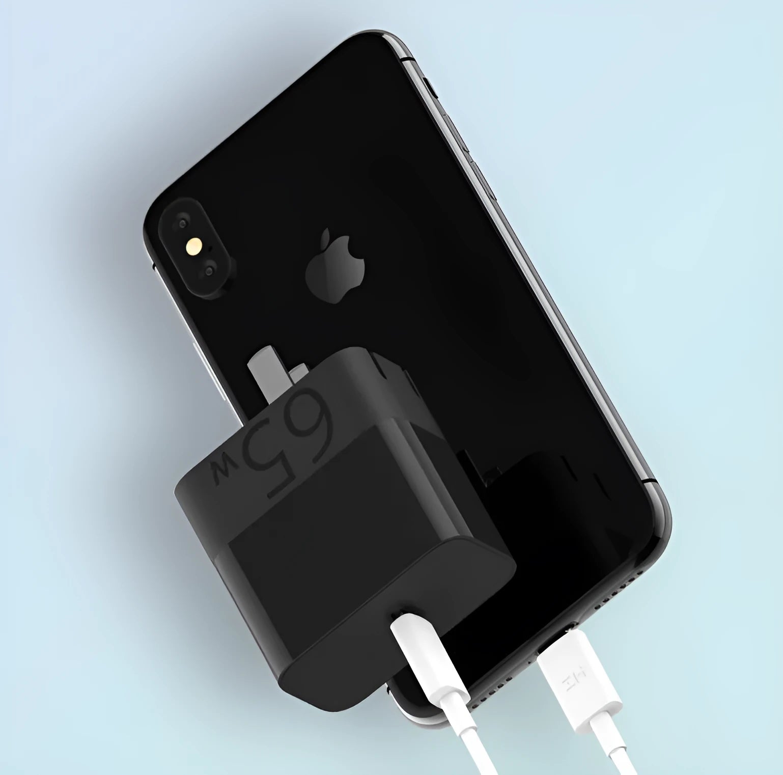 Black ZMI USB-C 65W compact laptop power adapter showing size comparison