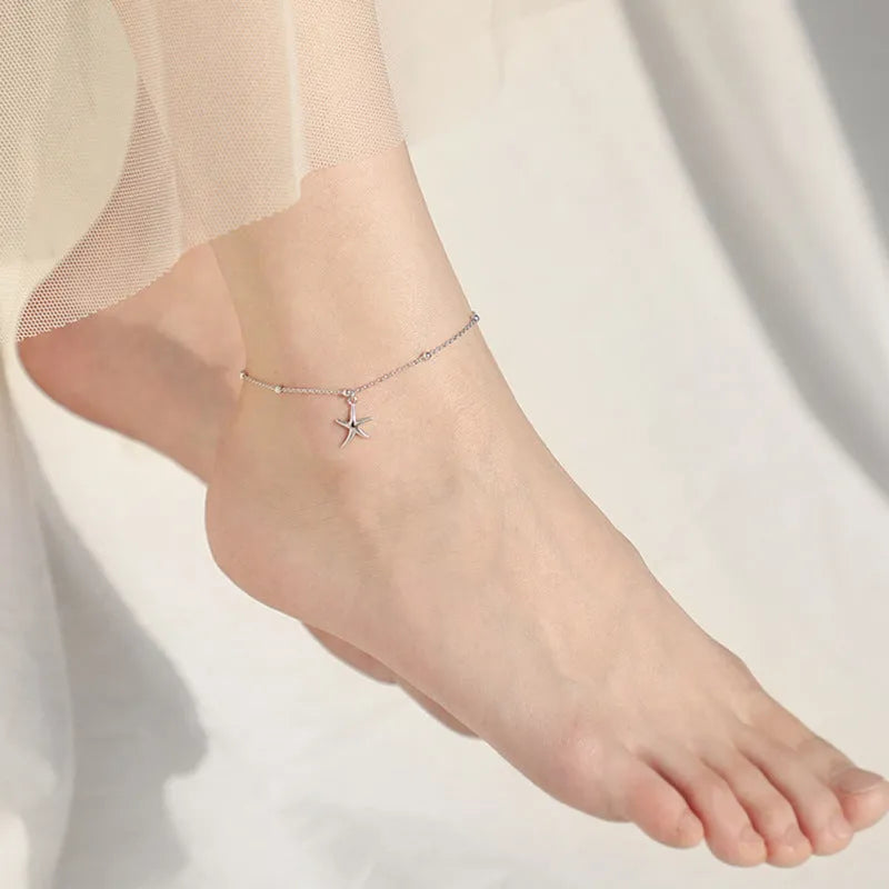 S925 sterling silver anklet with starfish charm and round beads on an adjustable chain.