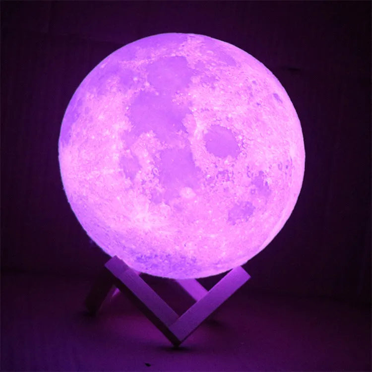3D printed white moon lamp on wooden stand with touch-sensitive metal ring at base.