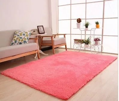 Solid colour plush carpet with soft surface and rectangular shape on hardwood floor