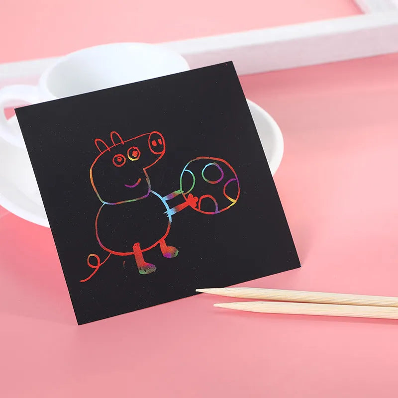 Colourful trumpet scratch art kit for children showing the design on the paper and the full presentation box.