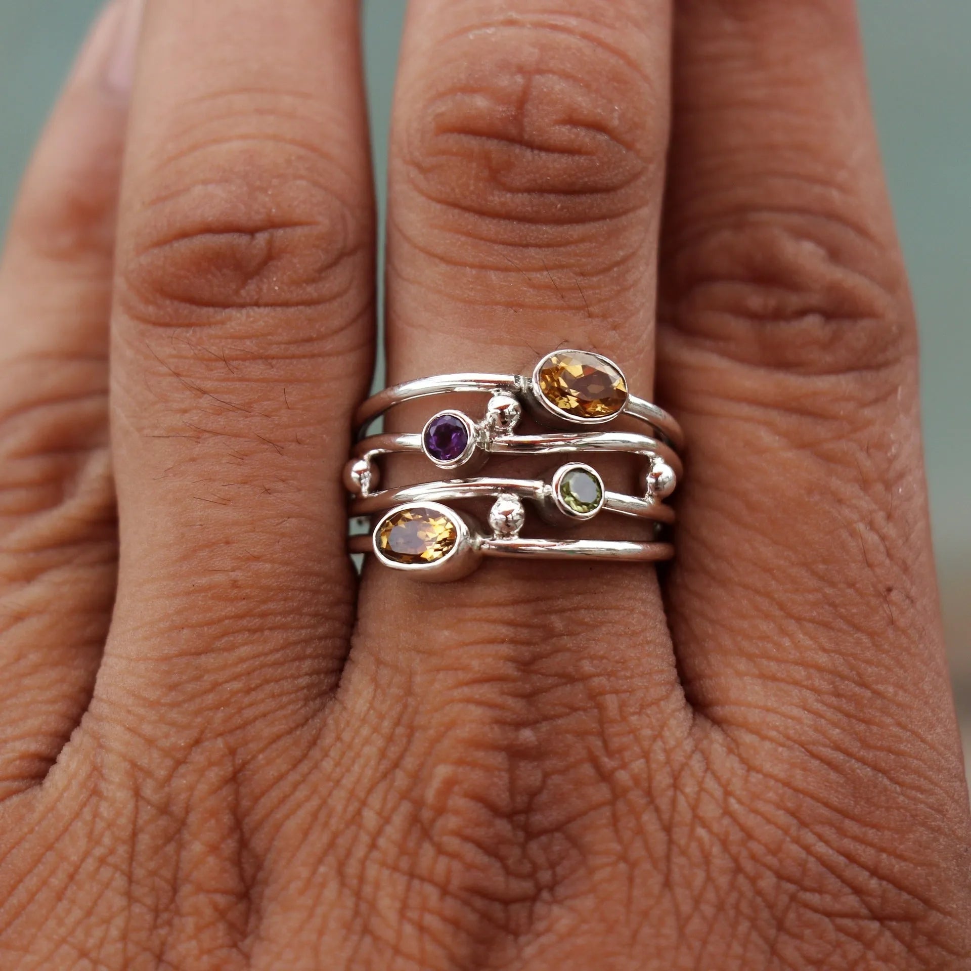 Silver bohemian diamond studded hollow copper ring with geometric ellipse shape on plain background
