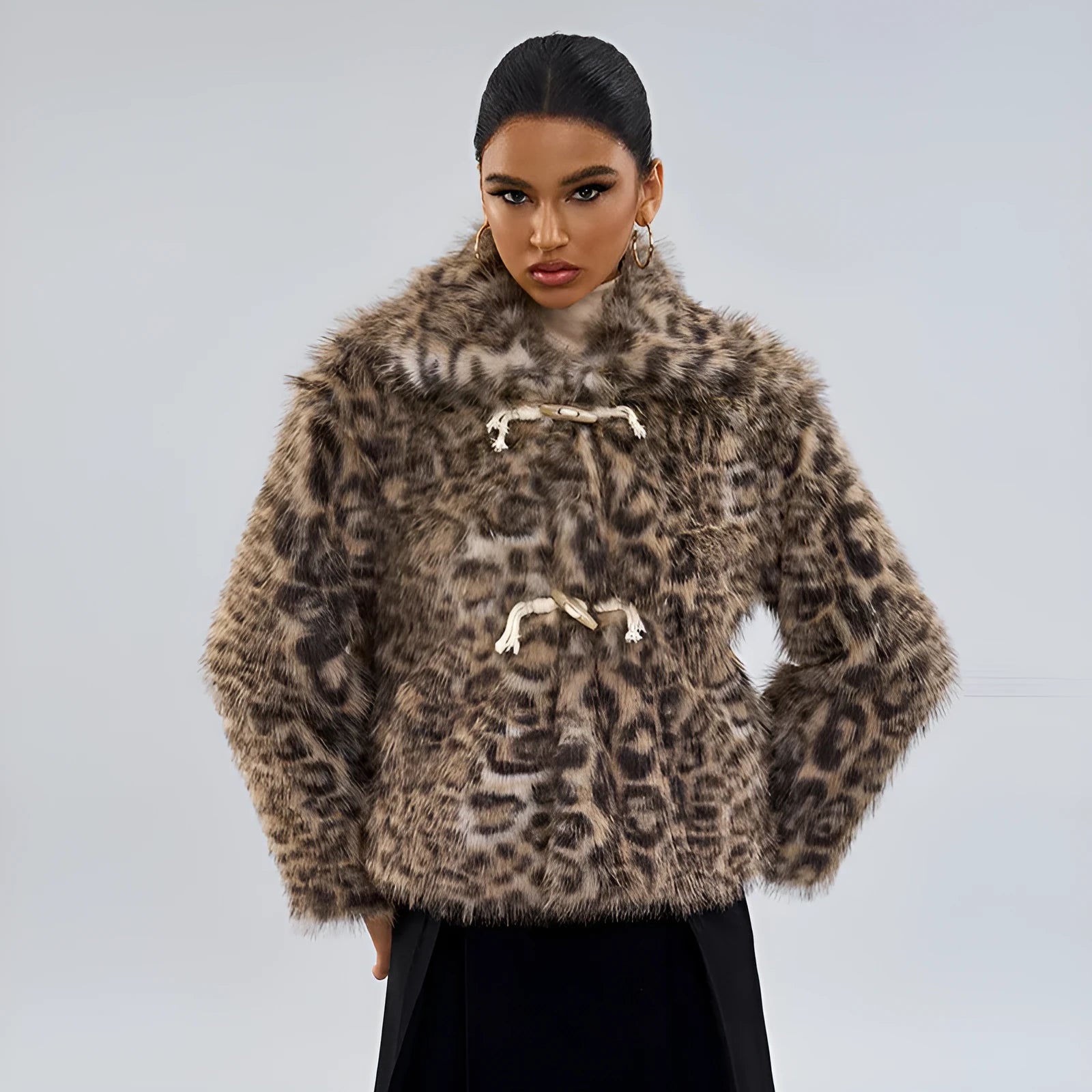 Women's leopard print coat with buckle lapel fastening on a hanger