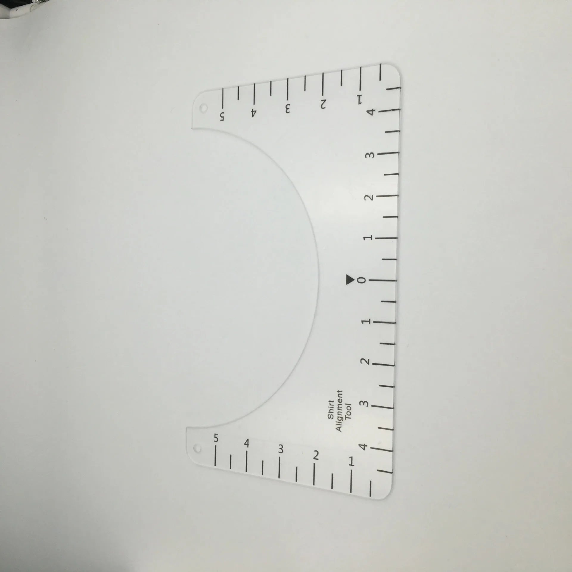Transparent acrylic sewing patch ruler measuring 10x6 inches for T-shirt alignment and garment construction