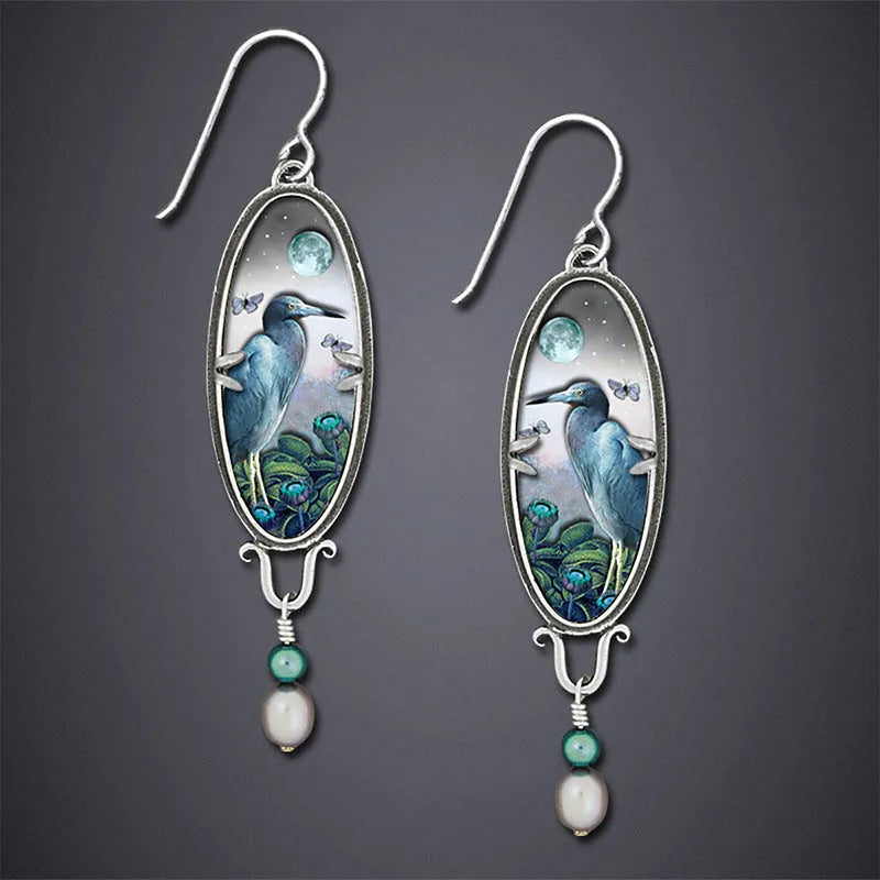 Silver retro-style women's drop earrings with a detailed bird and flower design.