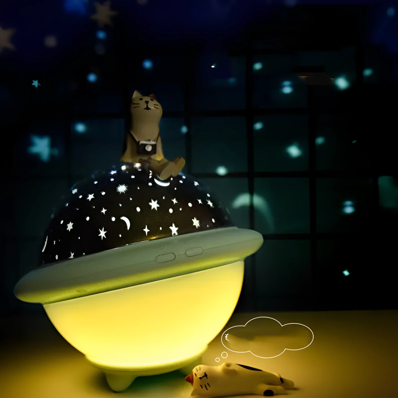 Green UFO-shaped star projection night light on wooden table showing star patterns on wall