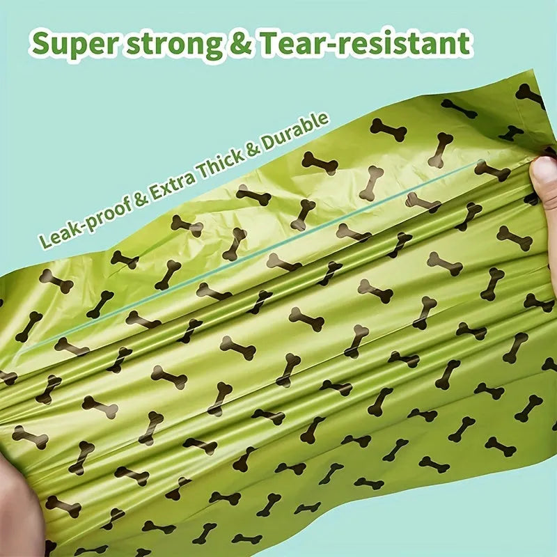 Biodegradable thickened dog poop bags in black and green on a roll with dispenser for pet waste cleanup.