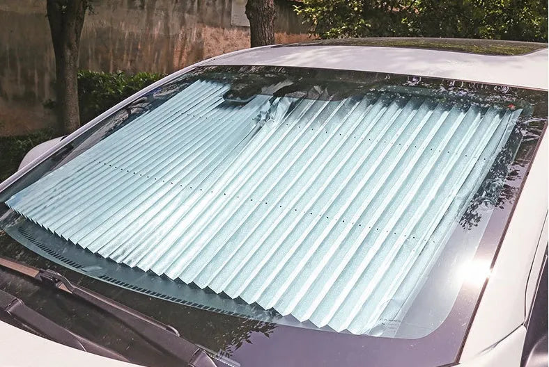 Car sun visor with aluminised film surface measuring 46cm clipped onto vehicle window