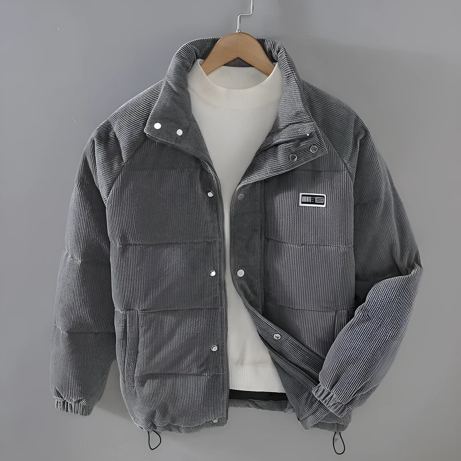 Men's puffer jacket in black with patch pockets, cardigan style, side view