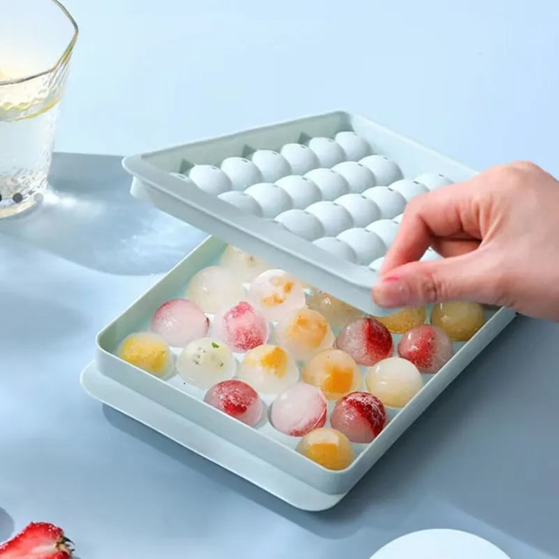 Blue round silicone ice cube tray with lid showing 33 mould cavities