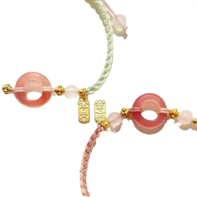 DIY woven watch band with peach blossom design in green, pink, and black colour options.
