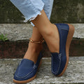 Women's black PU leather flat loafers with round toe and car suture design on a rubber sole.