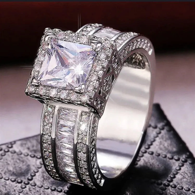 A geometric silver-tone women's ring with round elements, shown in gold and white colour options.