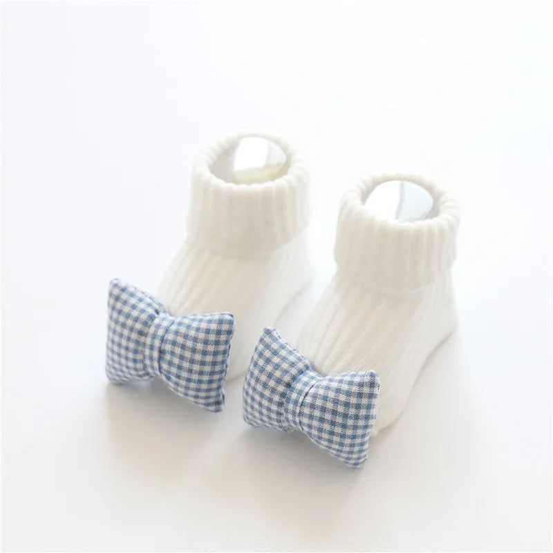 Cotton baby floor socks in multiple designs including panda, bow, and star patterns.