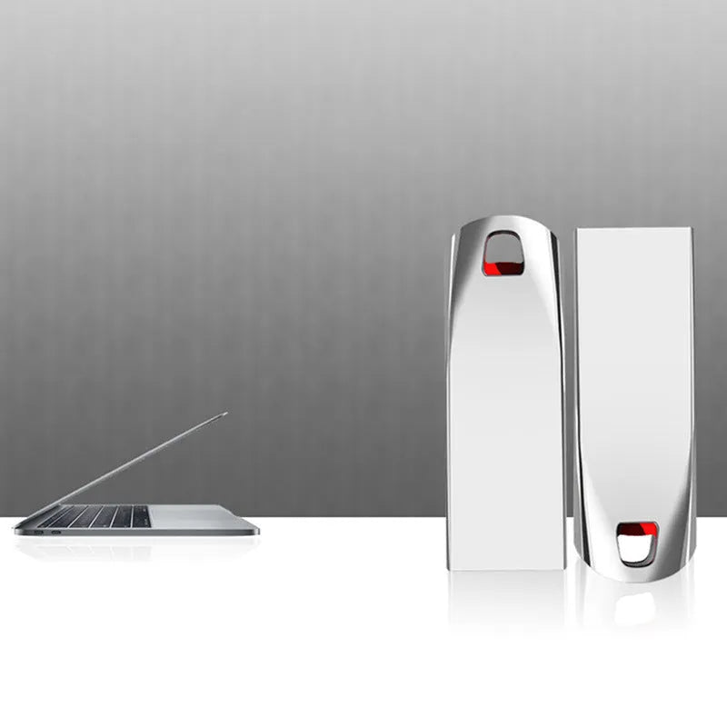Silver metal USB flash drive on a white background showing its USB connector.
