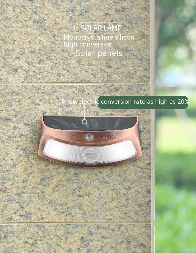 Solar-powered outdoor wall lamp with smiling face design for garden or courtyard lighting.