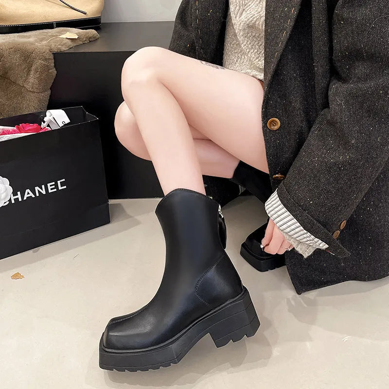 Black women's platform Martin boots with a square toe, high heel, and back zipper on a neutral background.