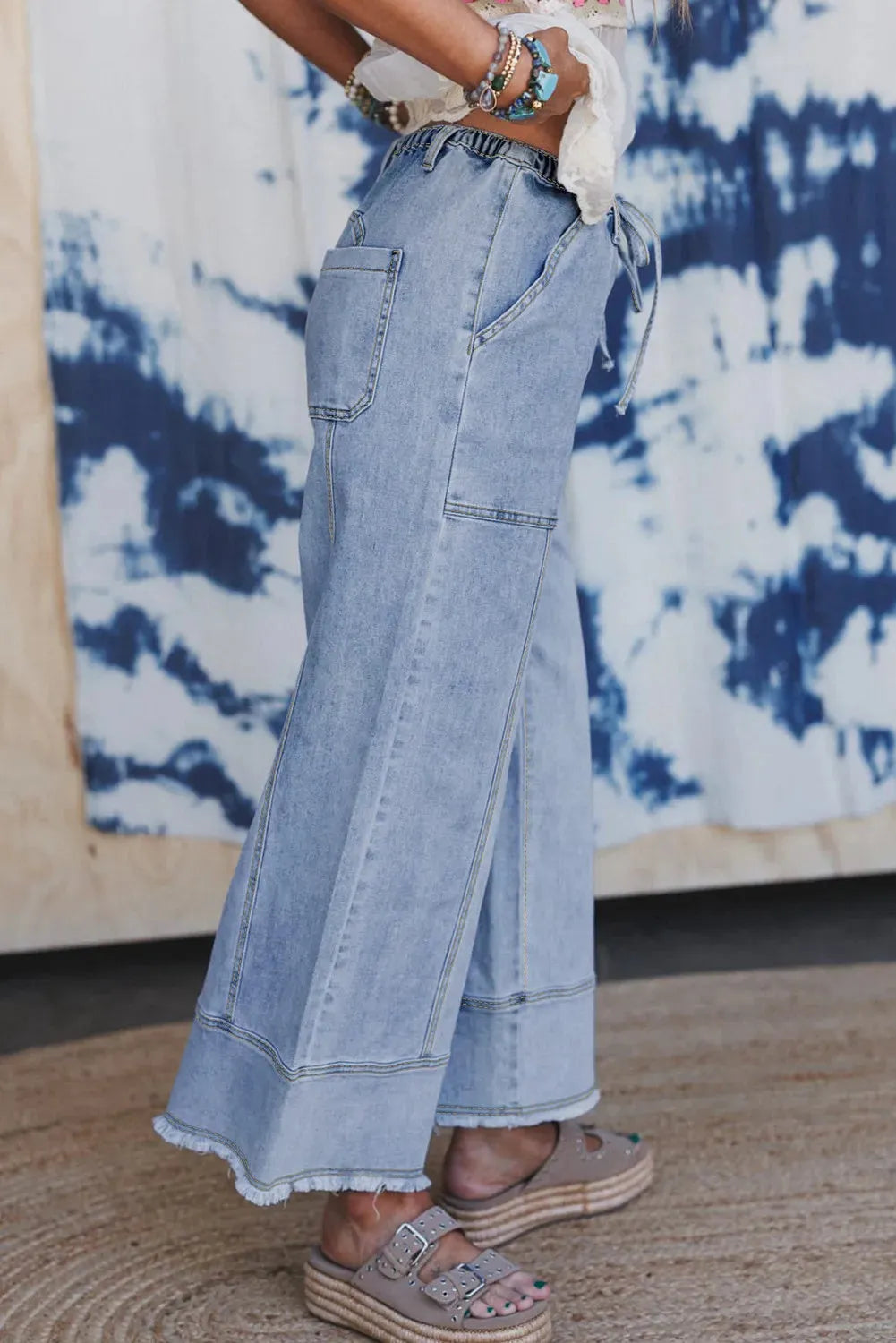 Beau Blue wide leg denim trousers with drawstring waist and raw unfinished hem detail