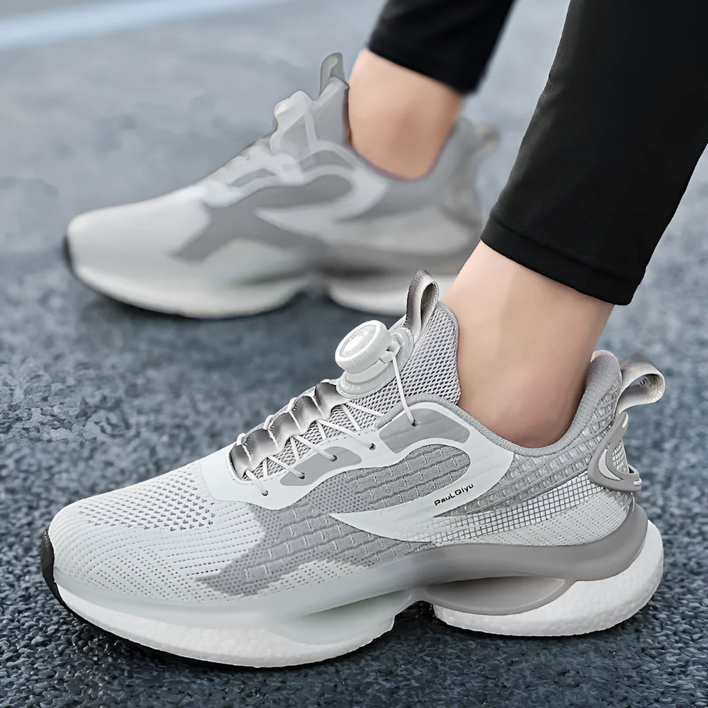 Men's white low-top running shoes with a rotating buckle fastener and breathable mesh upper.