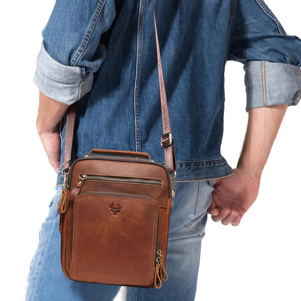 Men's brown genuine leather single-shoulder crossbody bag with visible stitching, shown on a model.