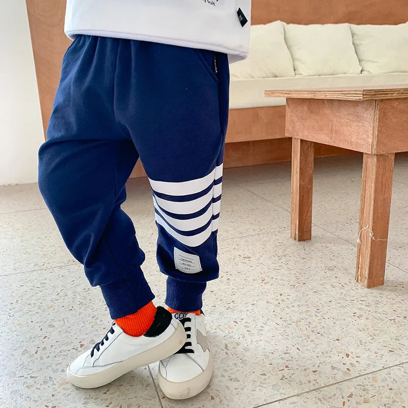 Boys' grey cotton sports trousers with elasticated waistband on child model