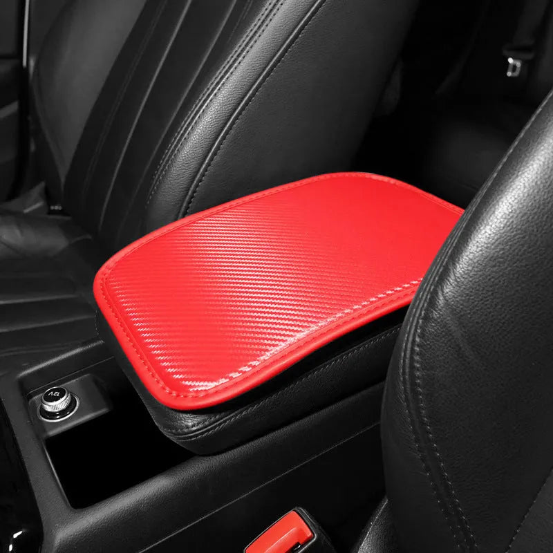 Carbon fibre pattern leather car armrest cushion mat in black, shown on a car centre console.