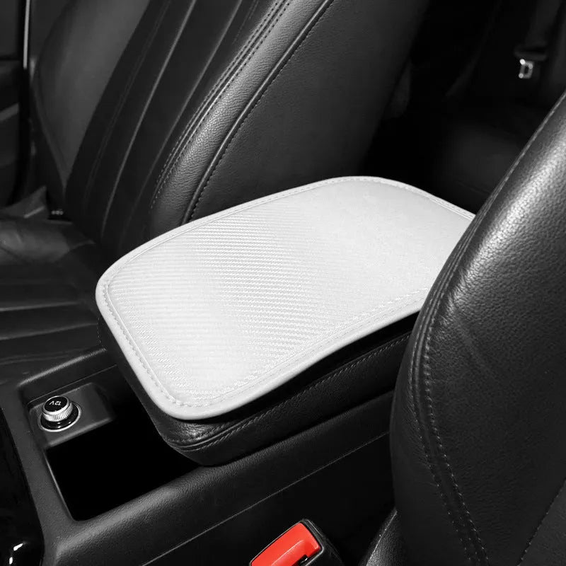 Carbon fibre pattern leather car armrest cushion mat in black, shown on a car centre console.