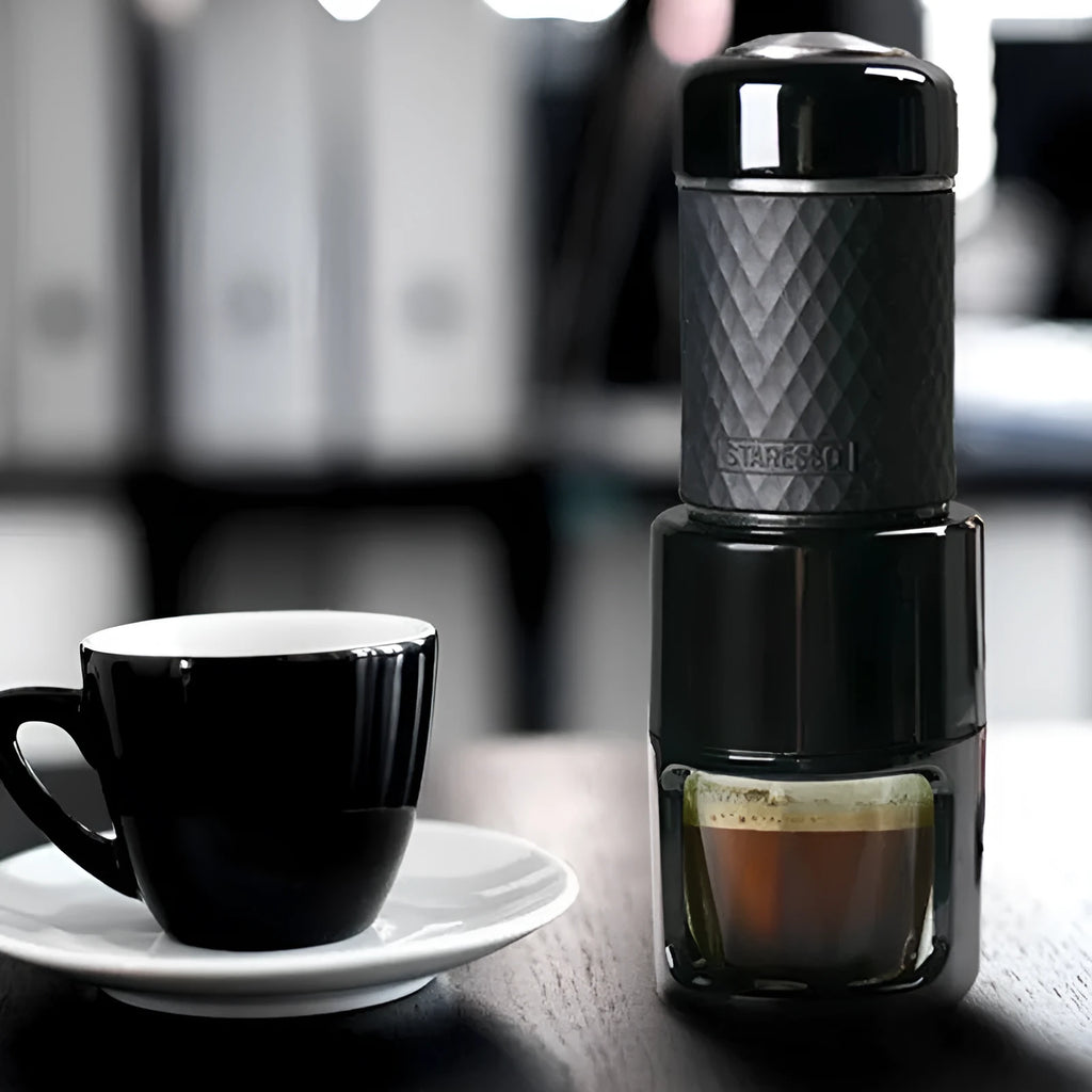 Portable manual espresso coffee machine in four colours with compact stainless steel design.