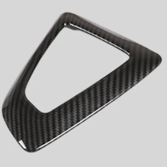 BMW gear selector base frame in carbon fibre pattern left titanium colour, showing 3M adhesive backing.