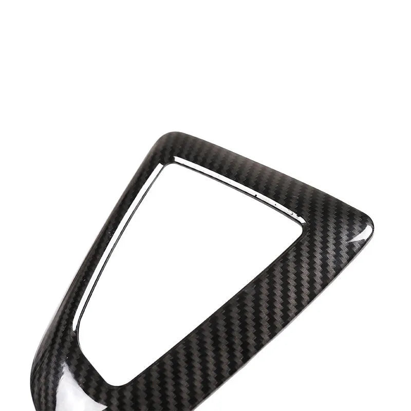 BMW gear selector base frame in carbon fibre pattern left titanium colour, showing 3M adhesive backing.