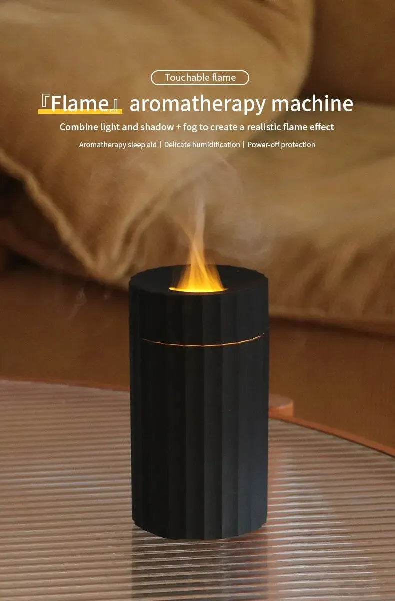 Black and white flame effect essential oil diffuser and air humidifier with coloured LED lights on a wooden table.