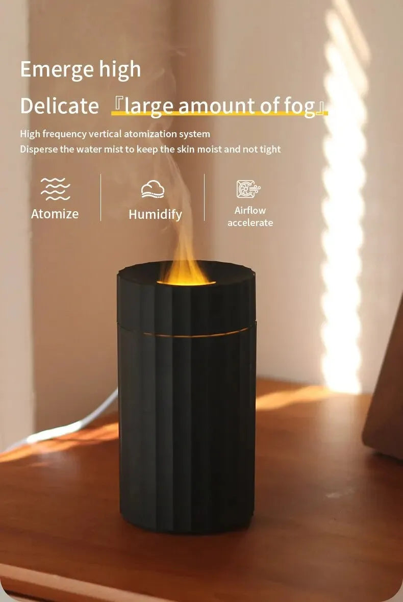 Black and white flame effect essential oil diffuser and air humidifier with coloured LED lights on a wooden table.