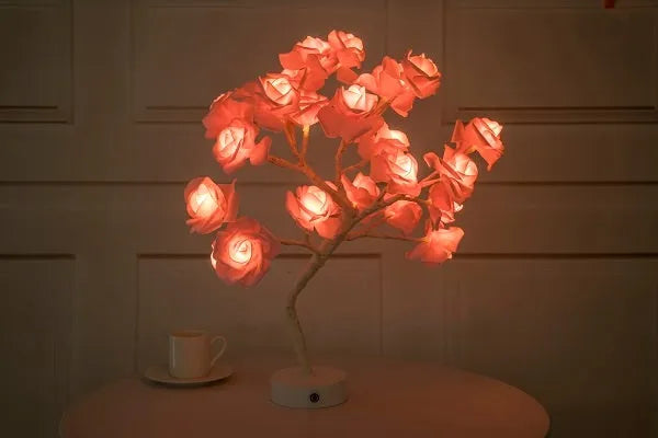 White and red rose flower LED table lamp with bonsai tree lights on a table.
