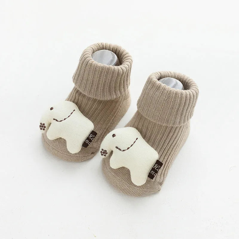 Baby socks with non-slip rubber grip soles on the feet, shown in a light grey colour.