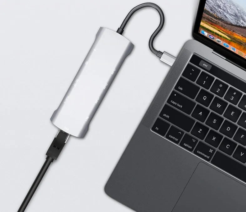 Grey aluminium USB C docking station with HDMI, VGA, and USB ports.