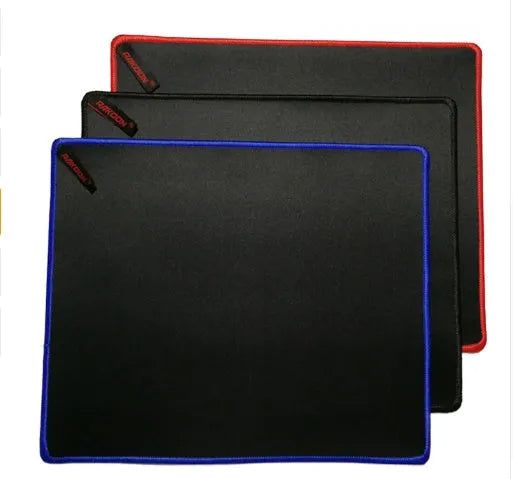 Solid colour locking edge large gaming mouse mat in black, 30x60 cm, on desk with keyboard and mouse