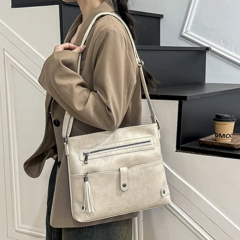 Women's soft PU tassel crossbody handbag in horizontal square shape with zipper compartments, available in beige, black, brown, coffee