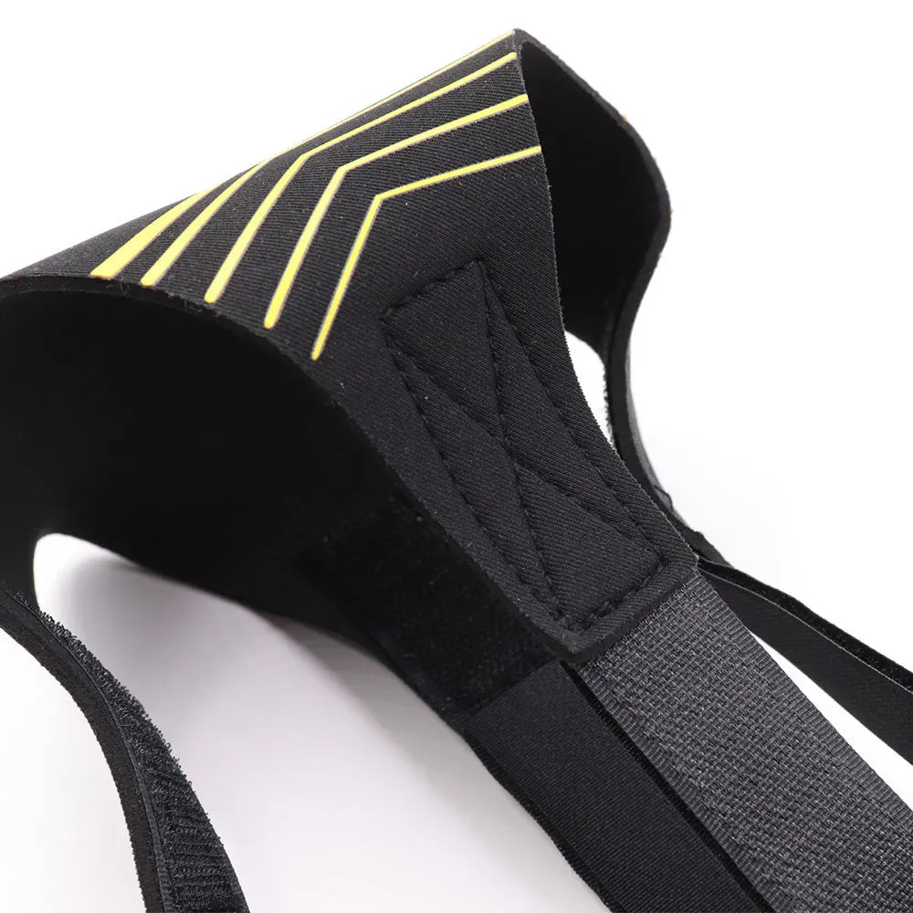 Black soccer training tether with adjustable waist belt and elastic Velcro strap on a green grass field